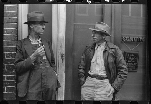Untitled photo, possibly related to: Two farmers talking outside of a main street bank, Roxboro, North Carolina, Memorial Day