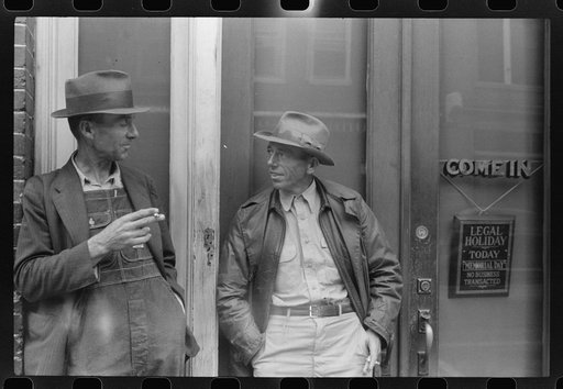 Two farmers talking in front of a bank in Roxboro, North Carolina