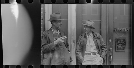 Untitled photo, possibly related to: Two farmers talking outside of a main street bank, Roxboro, North Carolina, Memorial Day