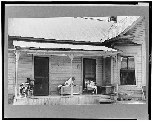 Negro children reading the comics on Sunday morning, Durham, North Carolina