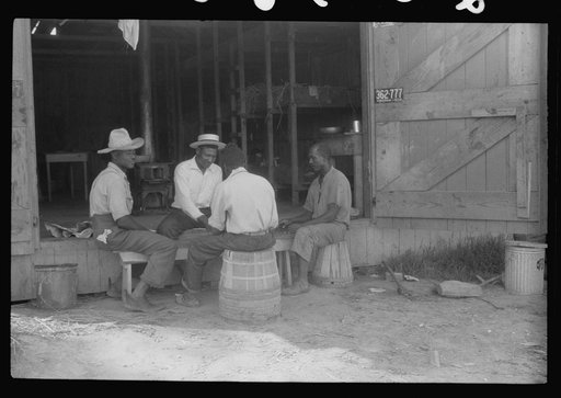 Untitled photo, possibly related to: Migratory agricultural workers at Picket's Landing, Virginia. Card games are frequent but money seldom used