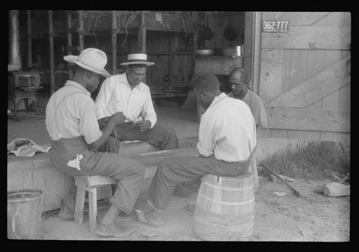 Migratory agricultural workers at Picket's Landing, Virginia. Card games are frequent but money seldom used