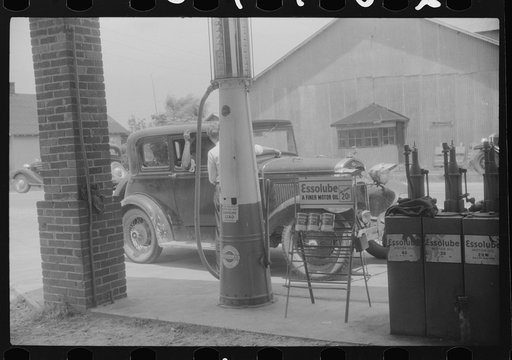 Untitled photo, possibly related to: Migratory agricultural workers getting gas at the store in Camden, North Carolina