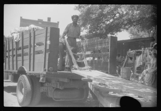 Untitled photo, possibly related to: An outdoor potato grader using migratory labor. At the freight station in Elizabeth City, North Carolina