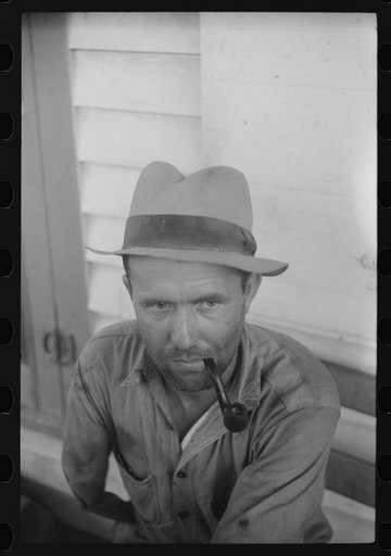 Untitled photo, possibly related to: This Texan worked at the grading station in Belcross, North Carolina. He was getting 20 cents an hour. His one wish was someday to have a 100 acre sweet potato farm of his own in Florida