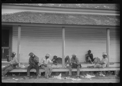 Migratory agricultural workers having supper at the store in Belcross, North Carolina
