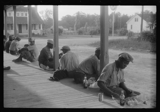 Untitled photo, possibly related to: Migratory agricultural workers having supper at the store in Belcross, North Carolina