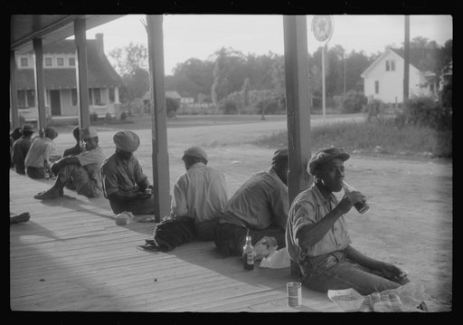 Migratory agricultural workers having supper at the store in Belcross, North Carolina