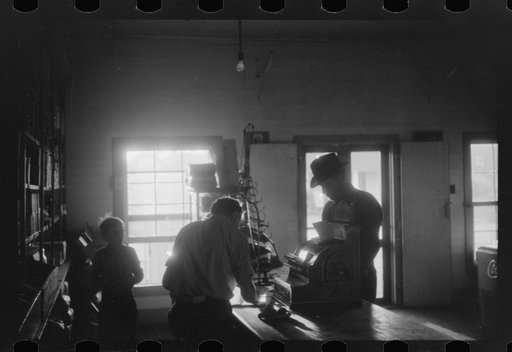 Untitled photo, possibly related to: Migratory agricultural workers buying canned goods for supper at the company store. Belcross, North Carolina