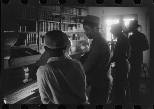 Untitled photo, possibly related to: Migratory agricultural workers buying canned goods for supper at the company store. Belcross, North Carolina
