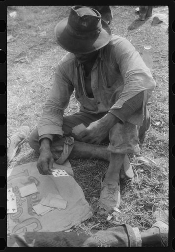 Untitled photo, possibly related to: Florida migratory agricultural worker, playing cards during lunch hour at the Belcross, North Carolina grading station.
