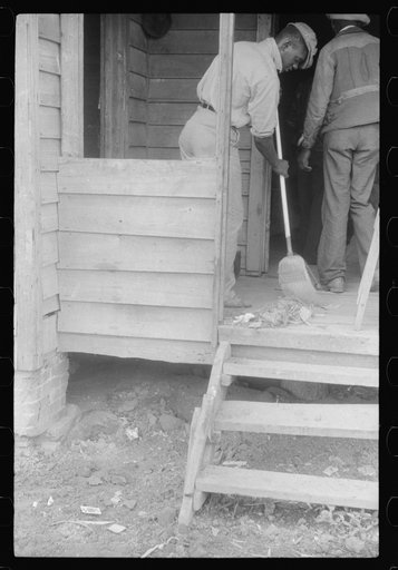 Migrant cleaning up the house before leaving Belcross, North Carolina for another job at Onley, Virginia