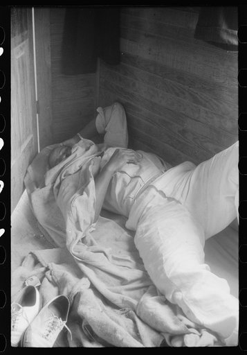 Sleeping quarters for migratory worker in a house on a potato field, near Belcross, North Carolina