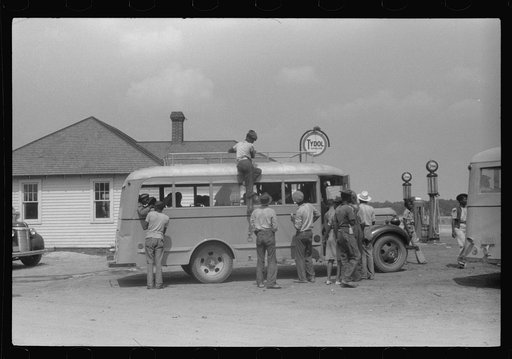 Migratory bean pickers being loaded into school buses for transportation to the bean fields. Statensville, Delaware