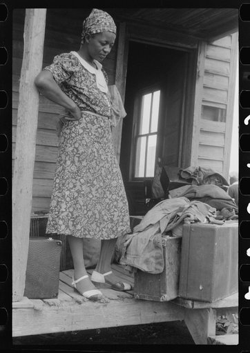 Georgia migratory agricultural worker waiting for the truck which will take her to another job at Onley, Virginia