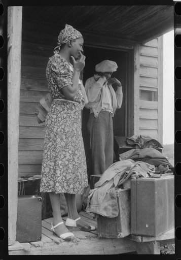 Georgia migratory agricultural worker waiting for the truck which will take her to another job at Onley, Virginia