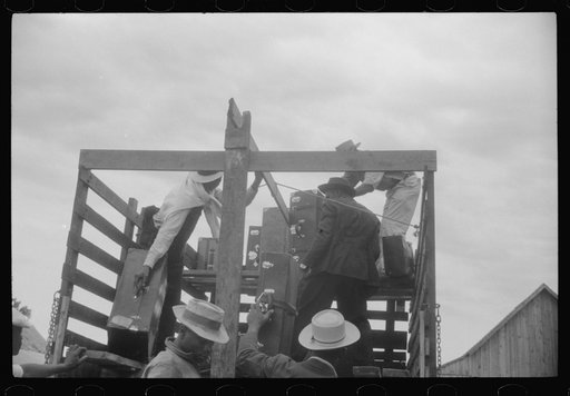 Migrants getting luggage aboard the truck which will take them from Belcross, North Carolina to another job at Onley, Virginia