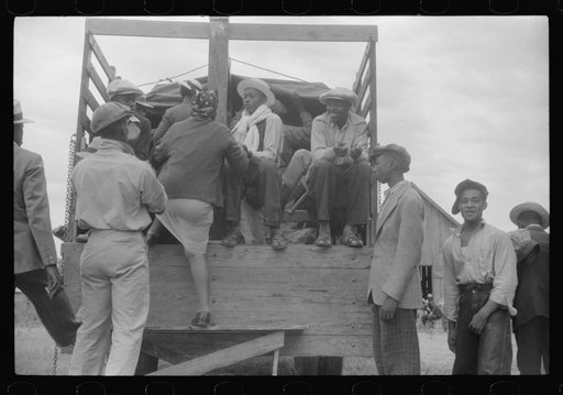 Florida migrants getting aboard the truck which will take them from Belcross, North Carolina to another job at Onley, Virginia