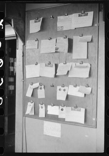 Untitled photo, possibly related to: Truck driver in front of bulletin board in a truck service station on U.S. 1 (New York Avenue) in Washington, D.C.