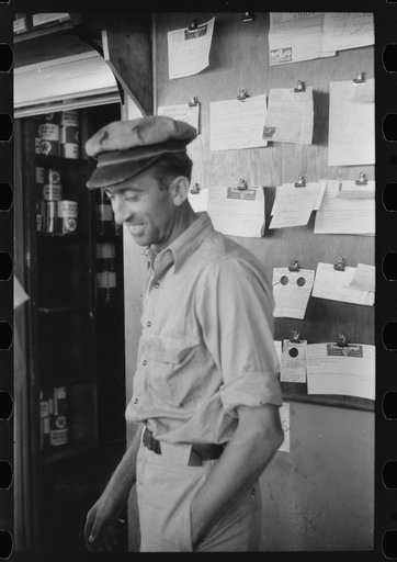 Truck driver in front of bulletin board in a truck service station on U.S. 1 (New York Avenue) in Washington, D.C.