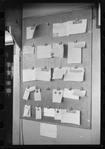 Untitled photo, possibly related to: Truck driver in front of bulletin board in a truck service station on U.S. 1 (New York Avenue) in Washington, D.C.