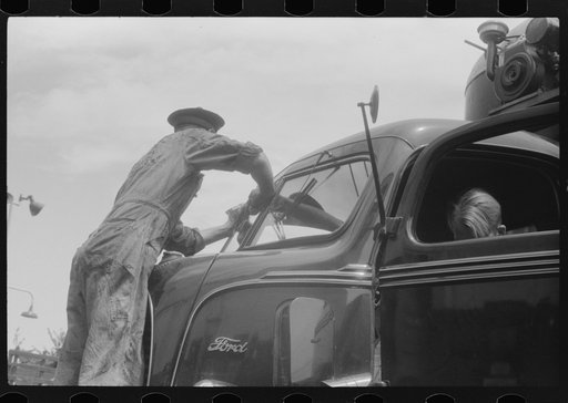 Untitled photo, possibly related to: Attendant at truck service station on U.S. 1 (New York Avenue) in Washington, D.C.