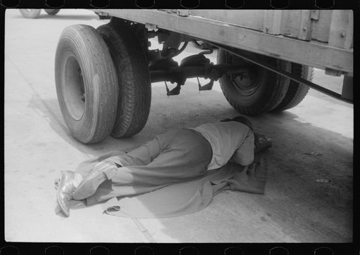 Untitled photo, possibly related to: Negro driver asleep under a truck. There are no sleeping accomodations for Negroes at this service station. On U.S. 1