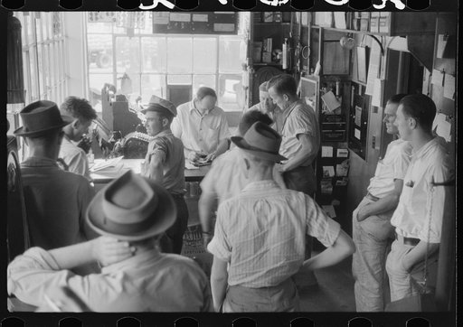 Untitled photo, possibly related to: Truck driver in front of bulletin board in a truck service station on U.S. 1 (New York Avenue) in Washington, D.C.