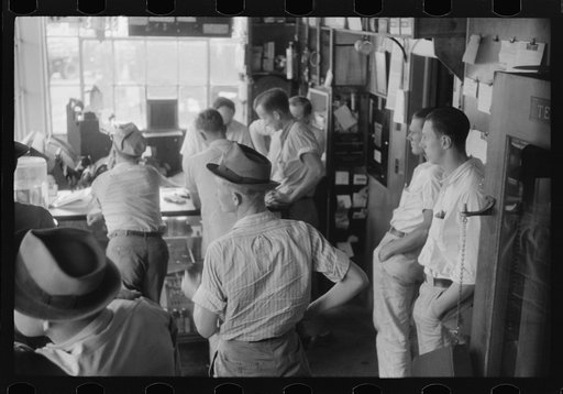 Untitled photo, possibly related to: Truck driver in front of bulletin board in a truck service station on U.S. 1 (New York Avenue) in Washington, D.C.