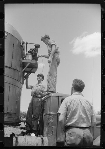 Starting up the motor of a refrigerator truck at a truck service station on U.S. 1 (New York Avenue), Washington, D.C.