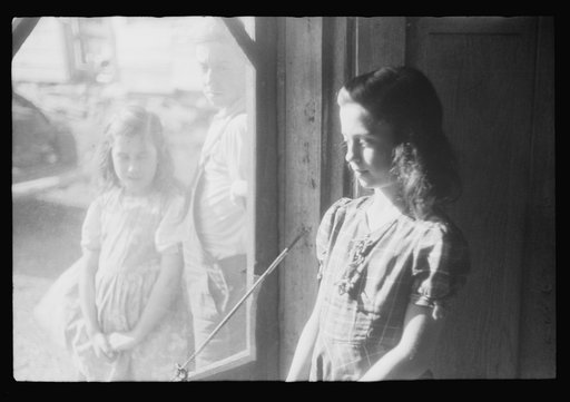 Untitled photo, possibly related to: Two of the Dumond children at the back door of their home in Lille, Maine. French-Canadian potato farmers and FSA (Farm Security Administration) clients