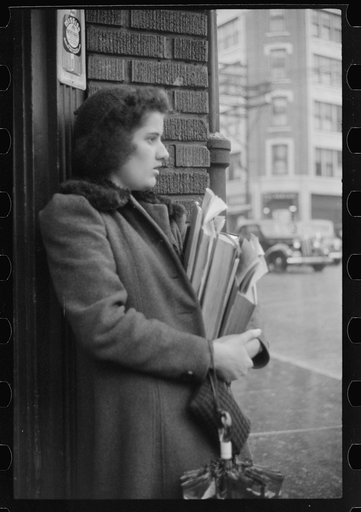Young school girl waiting for a bus on a rainy day in Norwich, Connecticut