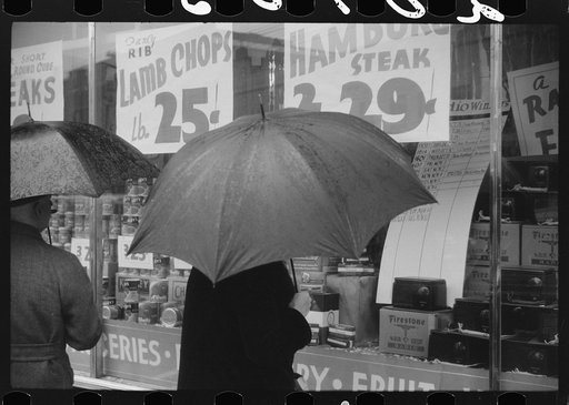 Untitled photo, possibly related to: Woman window shopping on a rainy day in Norwich, Connecticut