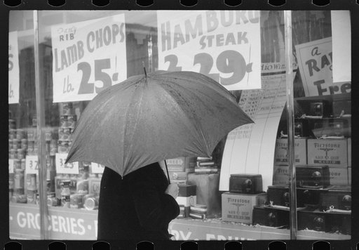 Woman window shopping on a rainy day in Norwich, Connecticut