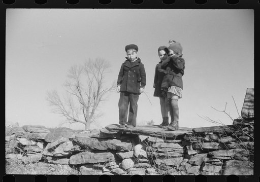 Small children waiting for their older brothers and sisters to be let out of school for lunch. Ledyard, Connecticut