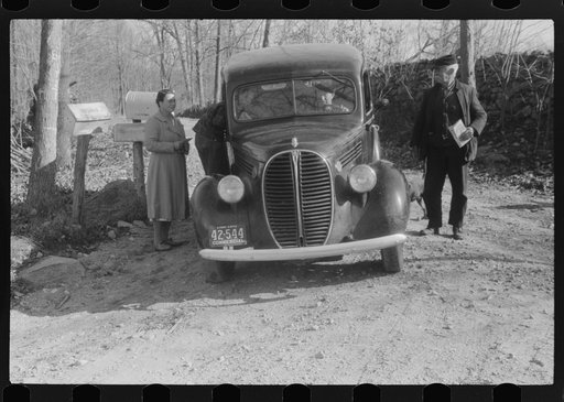 Some residents of Ledyard, Connecticut, receiving their mail from mail carrier at a crossroads