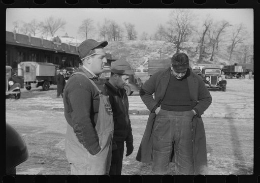 Untitled photo, possibly related to: Farmer at the Governor Dyer market keeping warm around a fire, Providence, Rhode Island