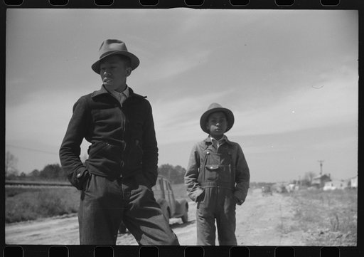 Untitled photo, possibly related to: Negro youngsters watching the construction of the prefabricated houses built by the FSA (Farm Security Administration) for farmers moved out of the Camp Croft area. Near Pacolet, South Carolina