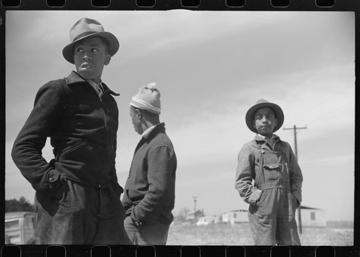 Negro youngsters watching the construction of the prefabricated houses built by the FSA (Farm Security Administration) for farmers moved out of the Camp Croft area. Near Pacolet, South Carolina