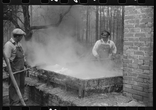 Untitled photo, possibly related to: Cleaning turpentine cups in boiling water at a still near Pembroke, Georgia