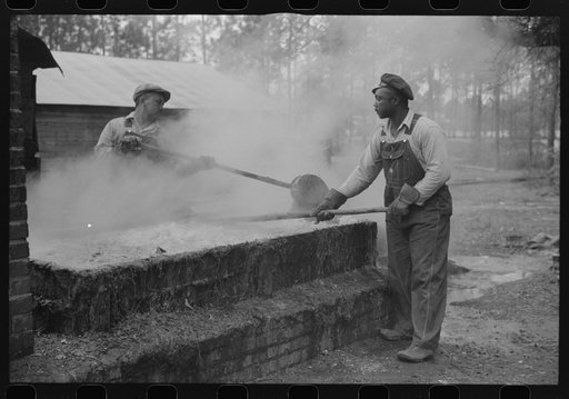 Cleaning turpentine cups in boiling water at a still near Pembroke, Georgia