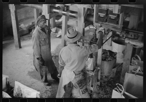 Filling paper sacks with hot rosin at a turpentine works in Statesboro, Georgia