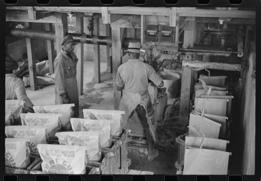 Filling paper sacks with hot rosin at a turpentine works in Statesboro, Georgia