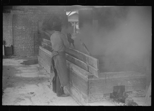Untitled photo, possibly related to: Filtering hot rosin through sieves at a turpentine works in Statesboro, Georgia