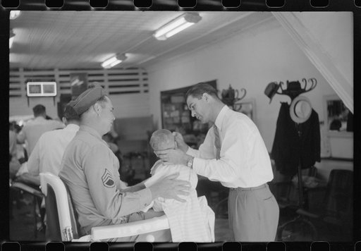Untitled photo, possibly related to: Sergeant from Fort Benning getting his son's hair cut at a barber shop in Columbus, Georgia