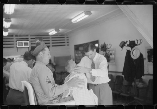 Untitled photo, possibly related to: Sergeant from Fort Benning getting his son's hair cut at a barber shop in Columbus, Georgia