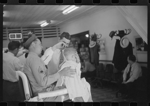 Untitled photo, possibly related to: Sergeant from Fort Benning getting his son's hair cut at a barber shop in Columbus, Georgia