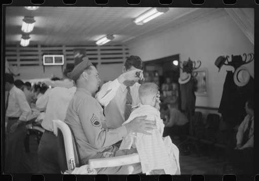 Untitled photo, possibly related to: Sergeant from Fort Benning getting his son's hair cut at a barber shop in Columbus, Georgia