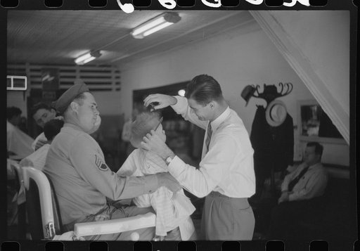 Untitled photo, possibly related to: Sergeant from Fort Benning getting his son's hair cut at a barber shop in Columbus, Georgia