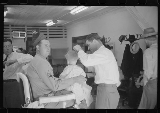 Untitled photo, possibly related to: Sergeant from Fort Benning getting his son's hair cut at a barber shop in Columbus, Georgia